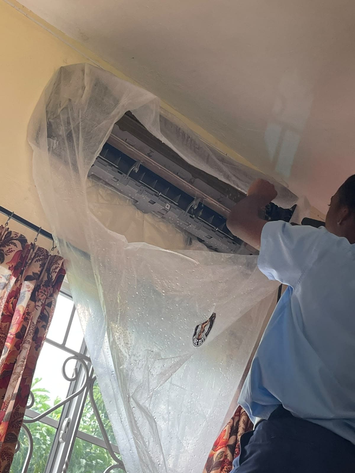 Indoor unit active servicing with wash bag shield